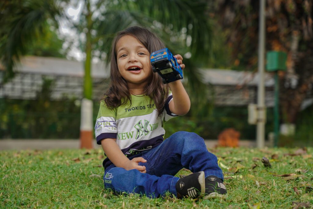 Childrens Photography 2025 2 Children Photography(Childhood Photography) showing a toy for playing in grass