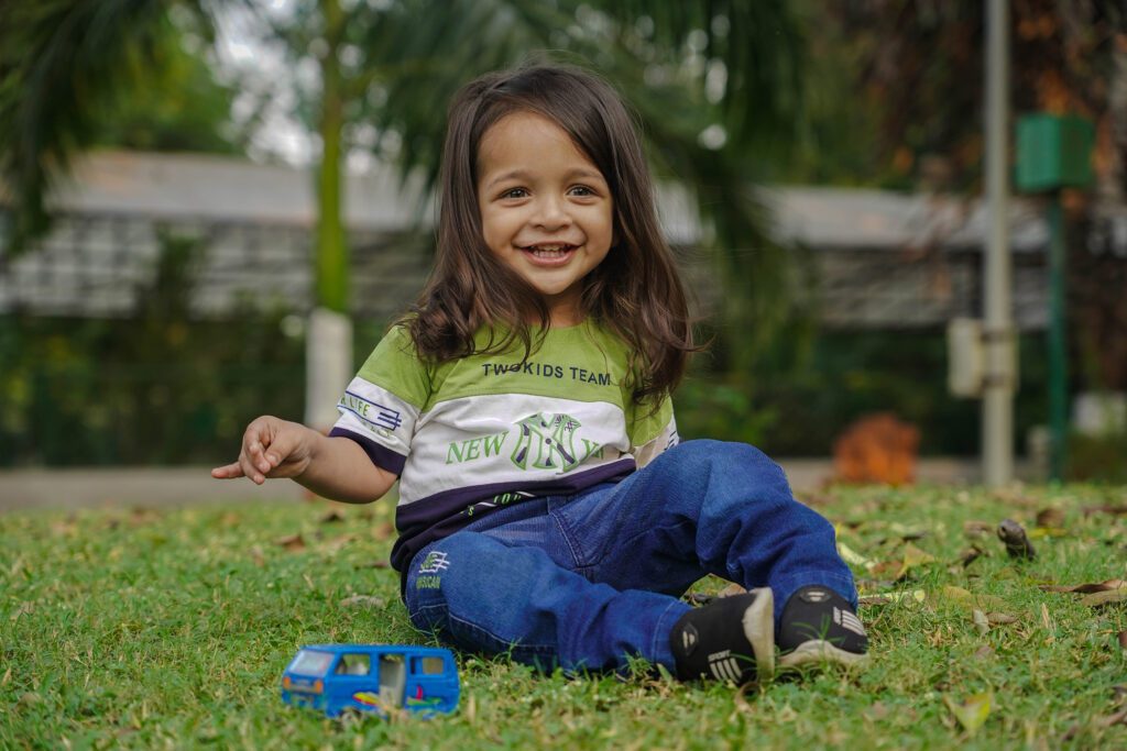 Childrens Photography 2025 1 Children Photography(Childhood Photography) smiling and playing with toys in grass