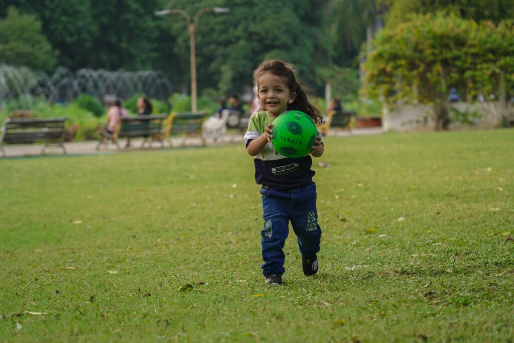 Children Photography(Childhood Photography) playing with ball in garden